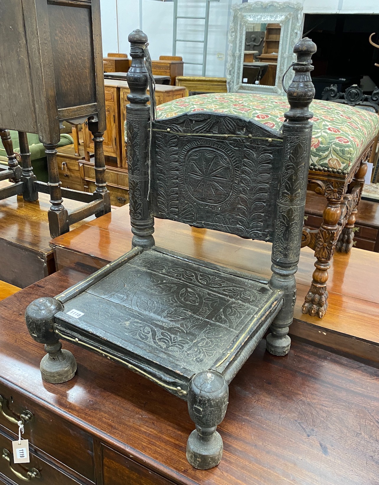 An Indian chip carved hardwood low seat chair, width 46cm, depth 43cm, height 71cm